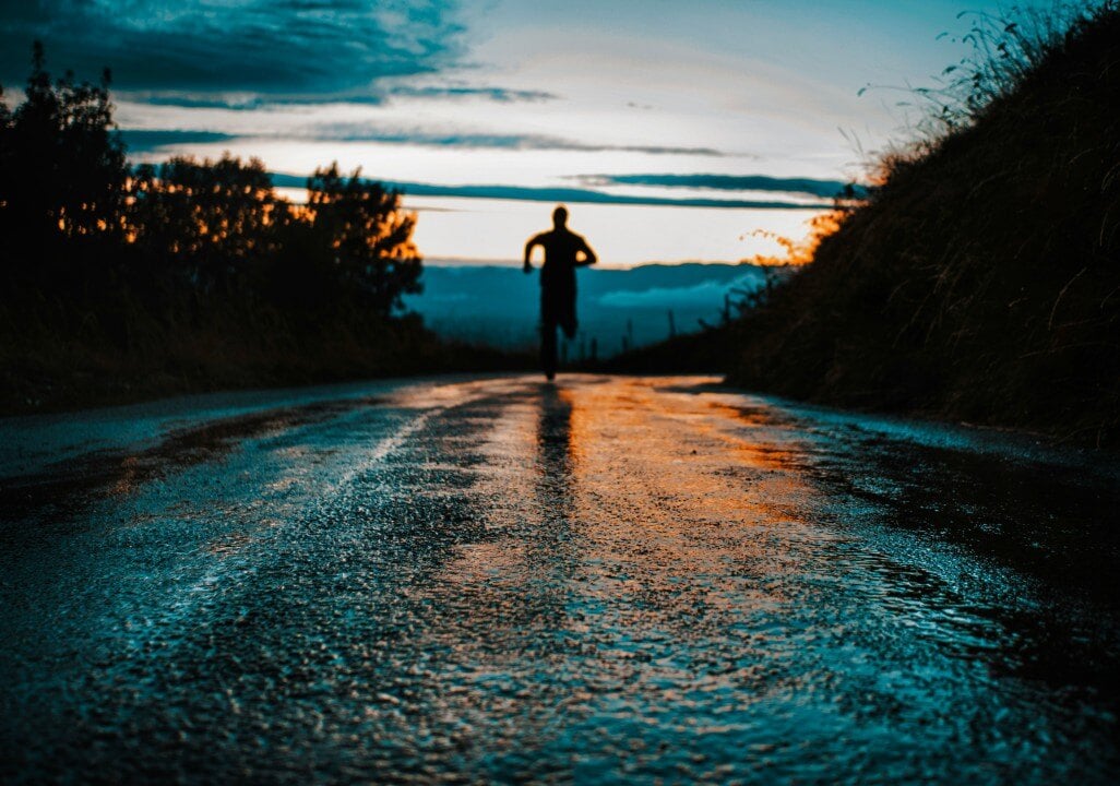 Person running outdoors on tarmac road